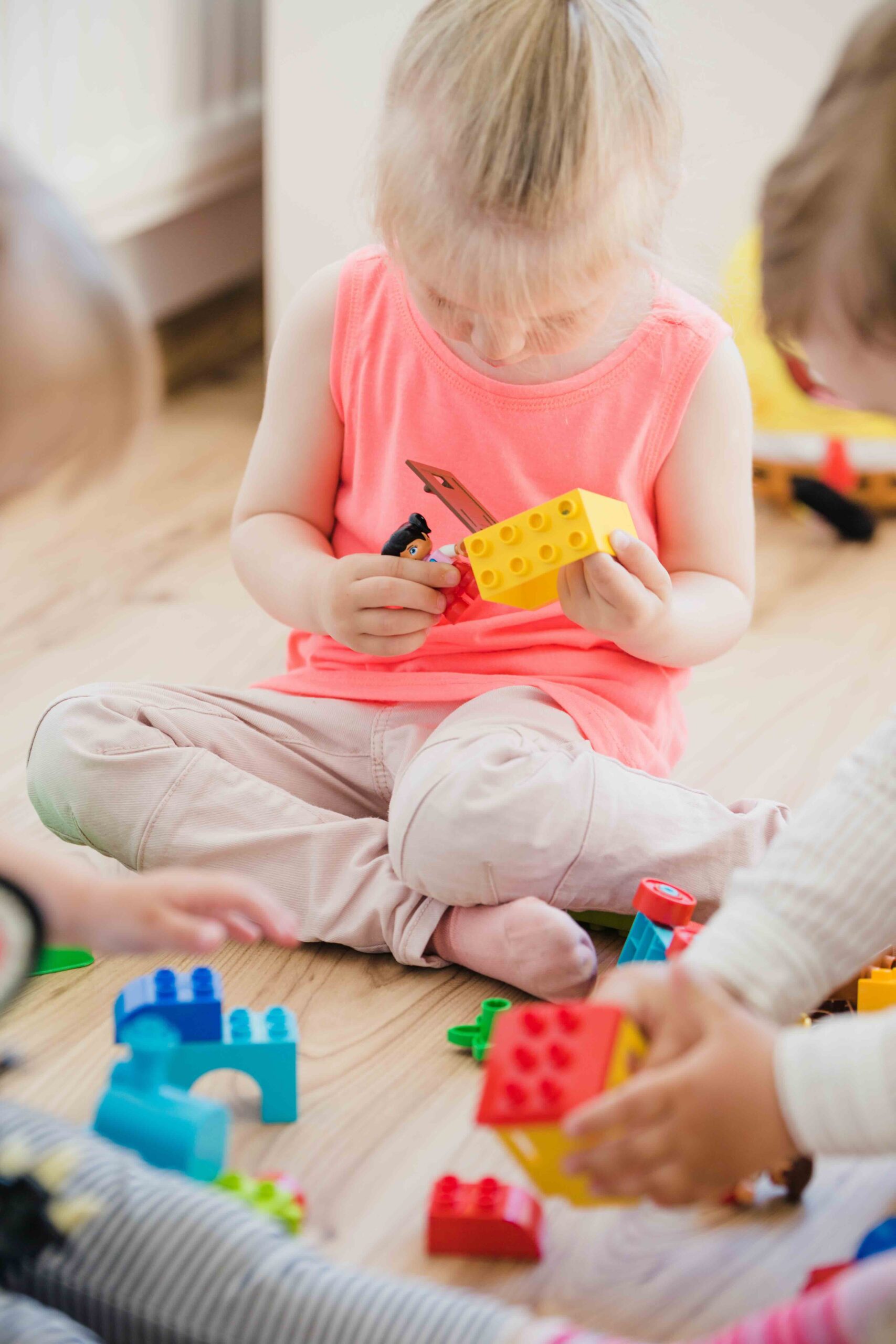 girl-sitting-floor-playing-with-toys